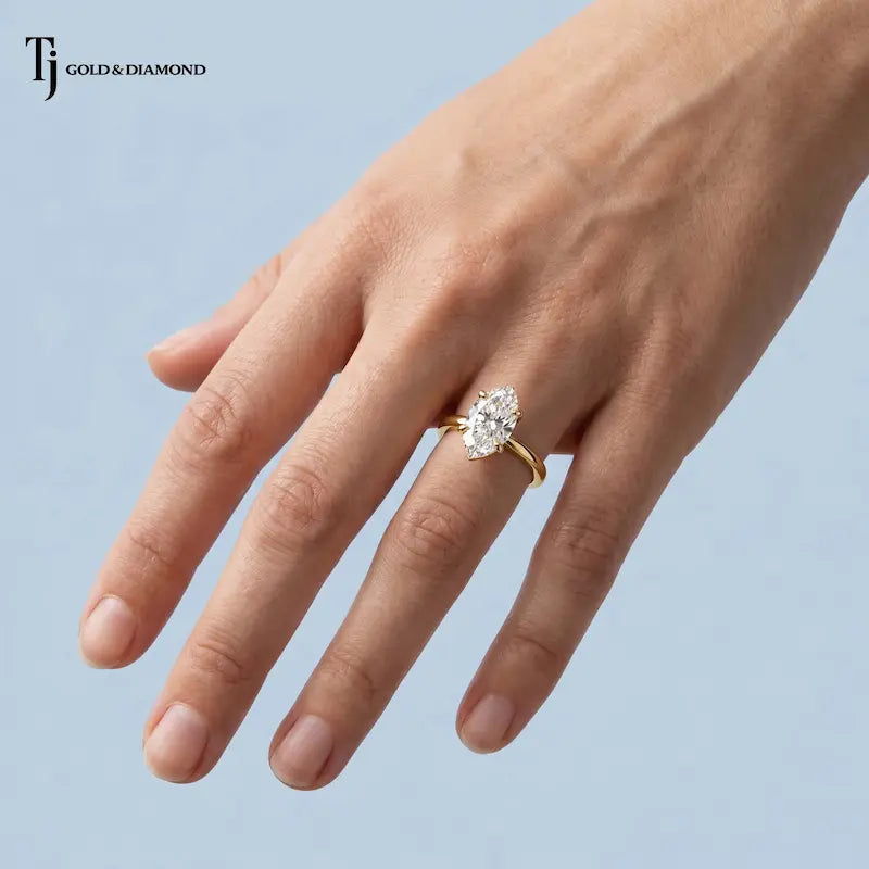 1.5 carat marquise cut lab-grown diamond solitaire engagement ring in 18kt yellow gold worn on hand