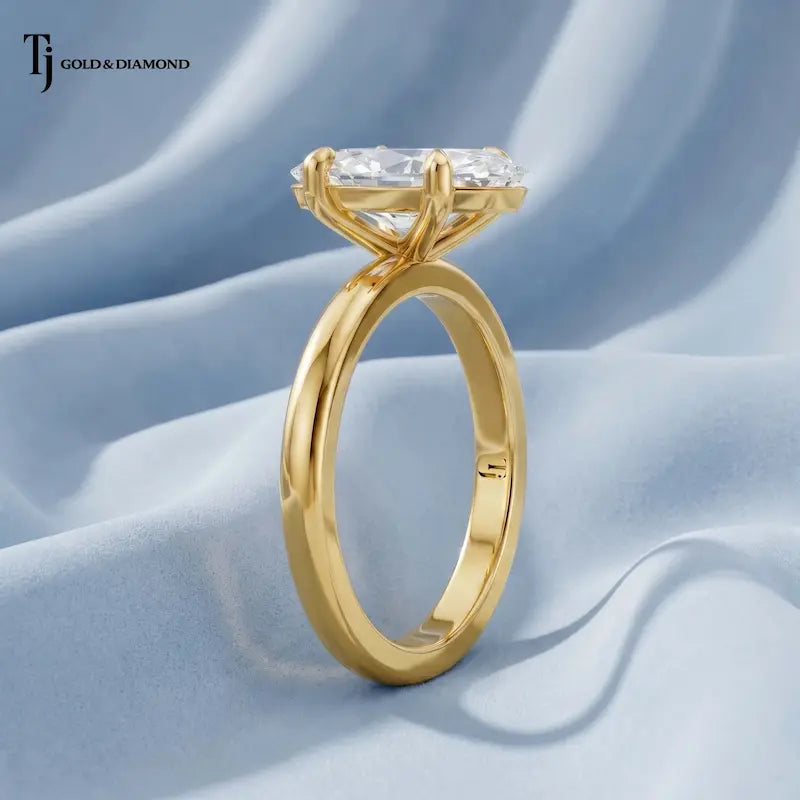 Side profile view of a 1.5 carat marquise cut lab-grown diamond solitaire engagement ring in 18kt yellow gold