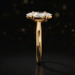Side profile of a 1.5 carat marquise cut diamond solitaire engagement ring showing the cathedral setting and 18kt yellow gold band by TJ Diamond