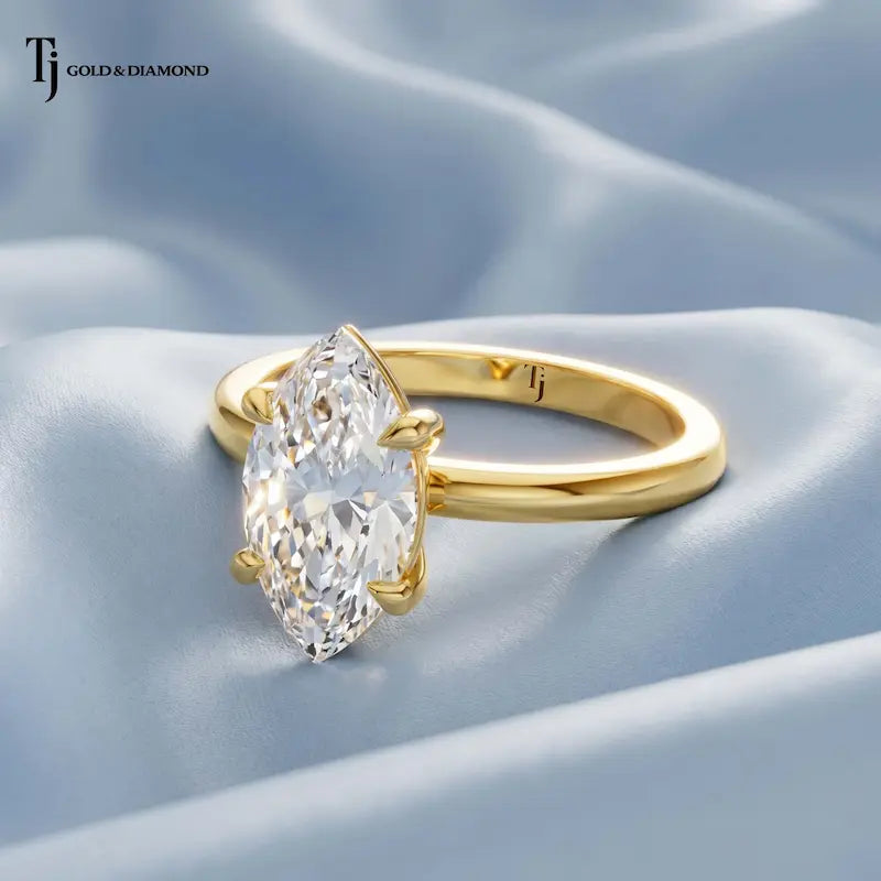 Side view of a 1.5 carat marquise cut lab-grown diamond solitaire engagement ring in 18kt yellow gold on satin