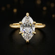 Front view of a 1.5 carat marquise cut diamond solitaire engagement ring in an 18kt yellow gold 6 claw setting by TJ Diamond