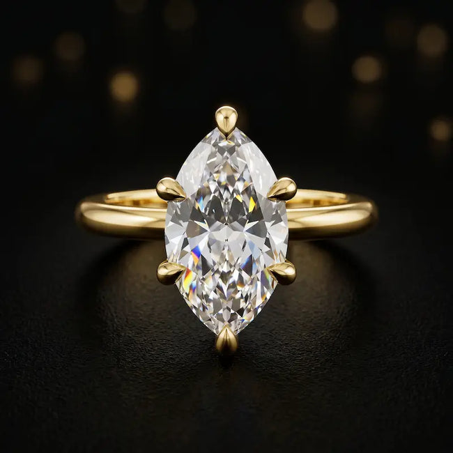 Front view of a 1.5 carat marquise cut diamond solitaire engagement ring in an 18kt yellow gold 6 claw setting by TJ Diamond