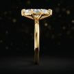 Side profile of a 1.5 carat marquise cut diamond solitaire engagement ring showing the cathedral setting and 18kt yellow gold band by TJ Diamond