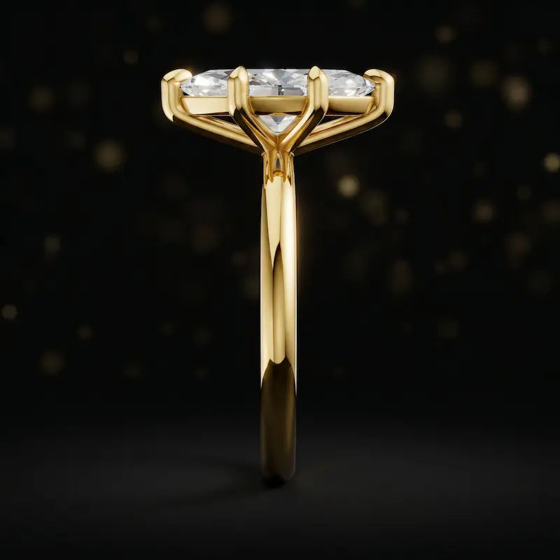 Side profile of a 1.5 carat marquise cut diamond solitaire engagement ring showing the cathedral setting and 18kt yellow gold band by TJ Diamond
