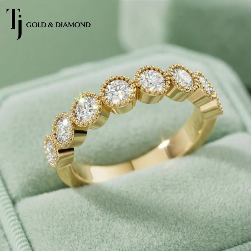 Top view of Milgrain Bezel Half Eternity diamond wedding band in 18kt yellow gold, showing round brilliant diamonds set in milgrain bezels