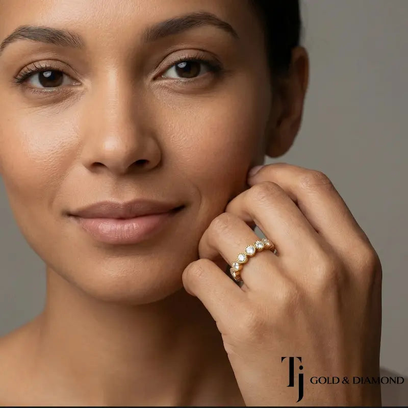 Model wearing a milgrain bezel setting full eternity diamond wedding band in 18kt yellow gold with round brilliant lab-grown diamonds.