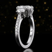Side profile of an oval cut three-stone lab-grown diamond engagement ring in 18kt white gold showing the diamond band