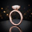Front view of 4-claw oval cut engagement ring with hidden halo in 18kt rose gold