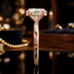 Side profile of 4-claw oval cut engagement ring with hidden halo in 18kt rose gold