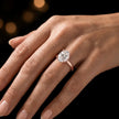 4-claw oval cut engagement ring with hidden halo in 18kt rose gold, worn on hand