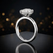 Front view of 4-claw oval cut engagement ring with hidden halo in 18kt white gold