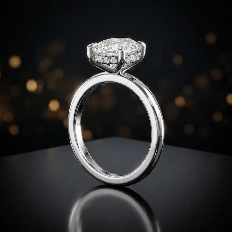 Front view of 4-claw oval cut engagement ring with hidden halo in 18kt white gold