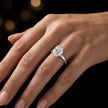 4-claw oval cut engagement ring with hidden halo in 18kt white gold, worn on hand