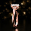 Side profile of a 1.5 carat oval cut diamond solitaire engagement ring showing the cathedral setting and 18kt rose gold band by TJ Diamond