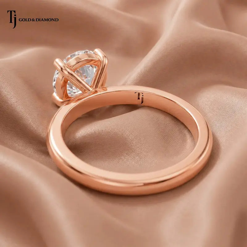 Back view of a 1.5 carat oval cut lab-grown diamond solitaire engagement ring in 18kt rose gold with a 4-claw setting