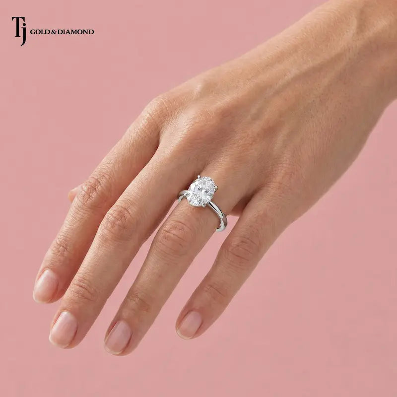 1.5 carat oval cut lab-grown diamond solitaire engagement ring in 18kt white gold worn on hand
