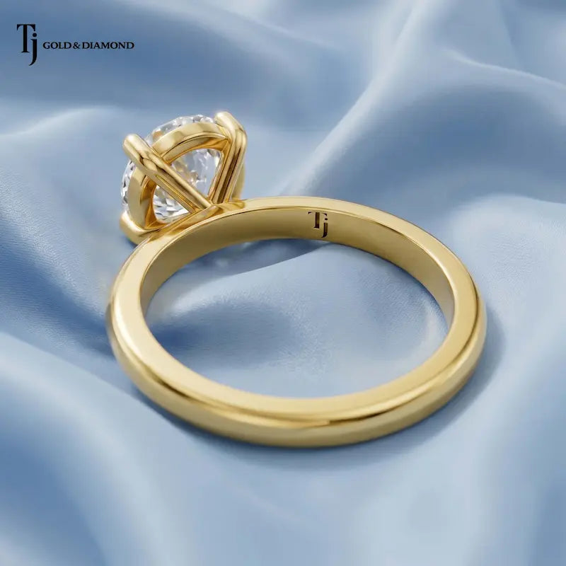 Back view of a 1.5 carat oval cut lab-grown diamond solitaire engagement ring in 18kt yellow gold with a 4-claw setting
