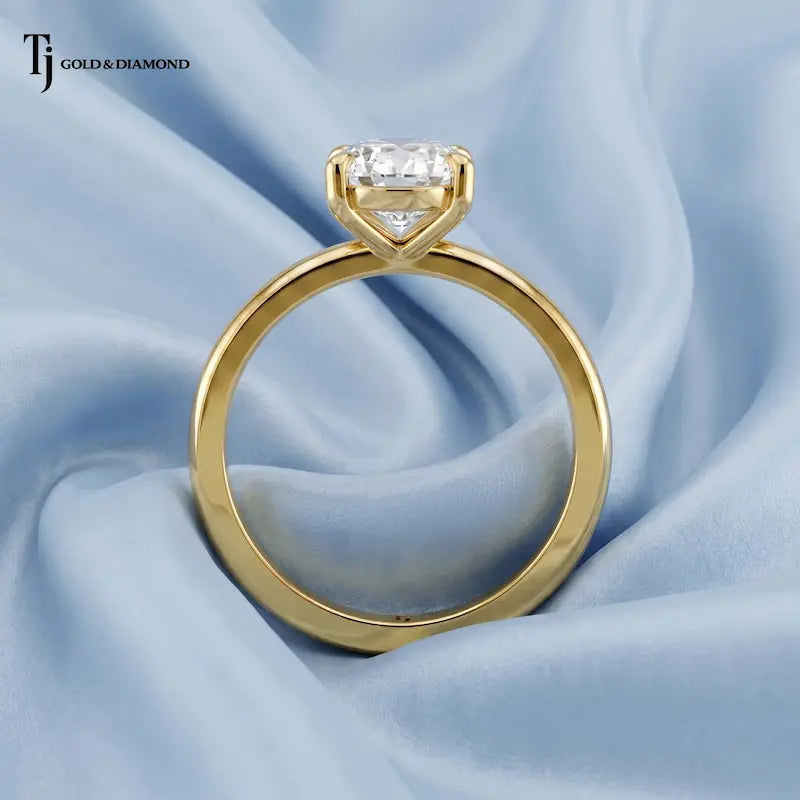 Front-on view of a 1.5 carat oval cut lab-grown diamond solitaire engagement ring in 18kt yellow gold with a 4-claw setting