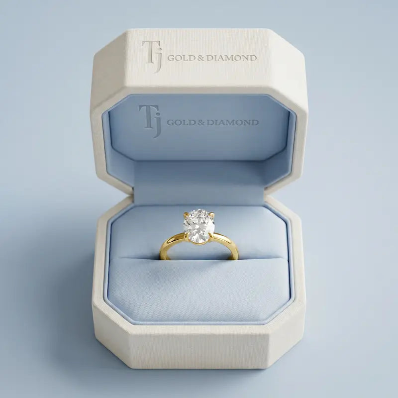 1.5 carat oval cut lab-grown diamond solitaire engagement ring in 18kt yellow gold in a TJ Diamond box