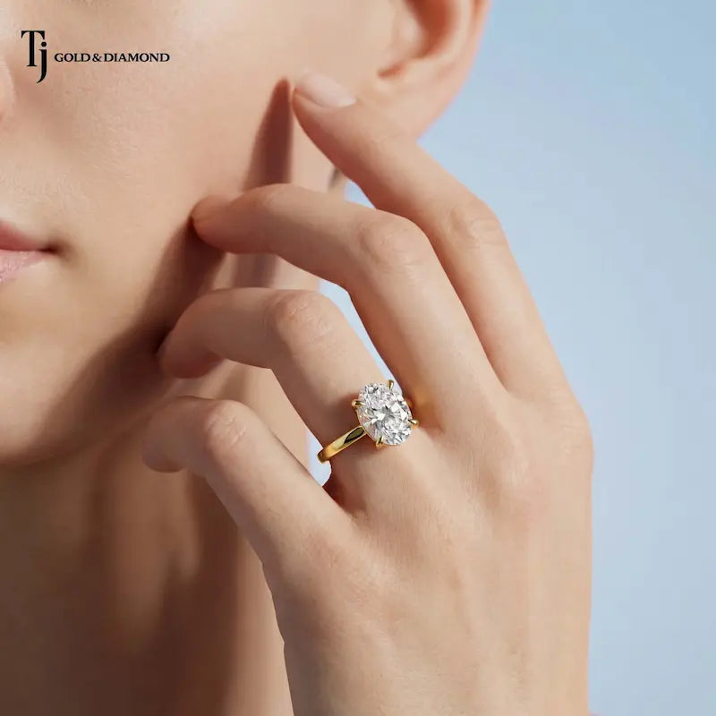 1.5 carat oval cut lab-grown diamond solitaire engagement ring in 18kt yellow gold on model