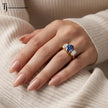 Oval Cut Lab-Created Blue Sapphire & Lab-Grown Diamond Trilogy Ring in 18kt yellow gold worn on hand showcasing its elegant trilogy design.