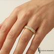 Pavé setting full eternity diamond wedding band in 18kt yellow gold worn on hand with round brilliant lab-grown diamonds.