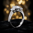Angled view of a pear cut three-stone lab-grown diamond engagement ring in 18kt white gold with diamond shoulders
