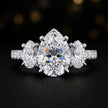 Front view of a pear cut three-stone lab-grown diamond engagement ring in 18kt white gold with diamond shoulders