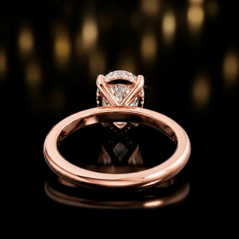 Back view of 4-claw pear cut engagement ring with hidden halo in 18kt rose gold