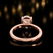 Back view of 4-claw pear cut engagement ring with hidden halo in 18kt rose gold