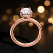 Front view of 4-claw pear cut engagement ring with hidden halo in 18kt rose gold