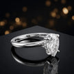 Angled view of 4-claw pear cut engagement ring with hidden halo in 18kt white gold