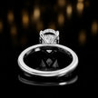 Back view of 4-claw pear cut engagement ring with hidden halo in 18kt white gold