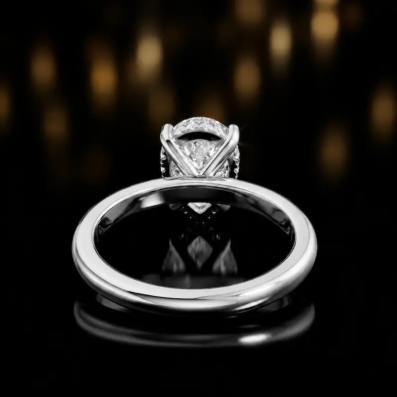 Back view of 4-claw pear cut engagement ring with hidden halo in 18kt white gold