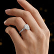 4-claw pear cut engagement ring with hidden halo in 18kt white gold, worn on hand