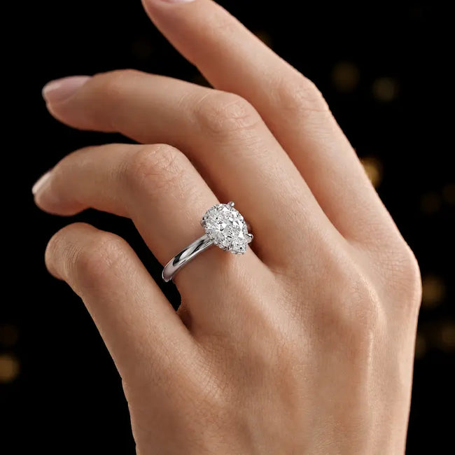 4-claw pear cut engagement ring with hidden halo in 18kt white gold, worn on hand