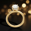 Front view of 4-claw pear cut engagement ring with hidden halo in 18kt yellow gold