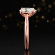 Side profile of a 1.5 carat pear cut diamond solitaire engagement ring showing the cathedral setting and 18kt rose gold band by TJ Diamond