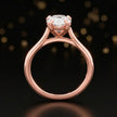 Front-on view of a 1.5 carat pear cut diamond solitaire engagement ring showing the full 18kt rose gold band and 4 claw cathedral setting by TJ Diamond