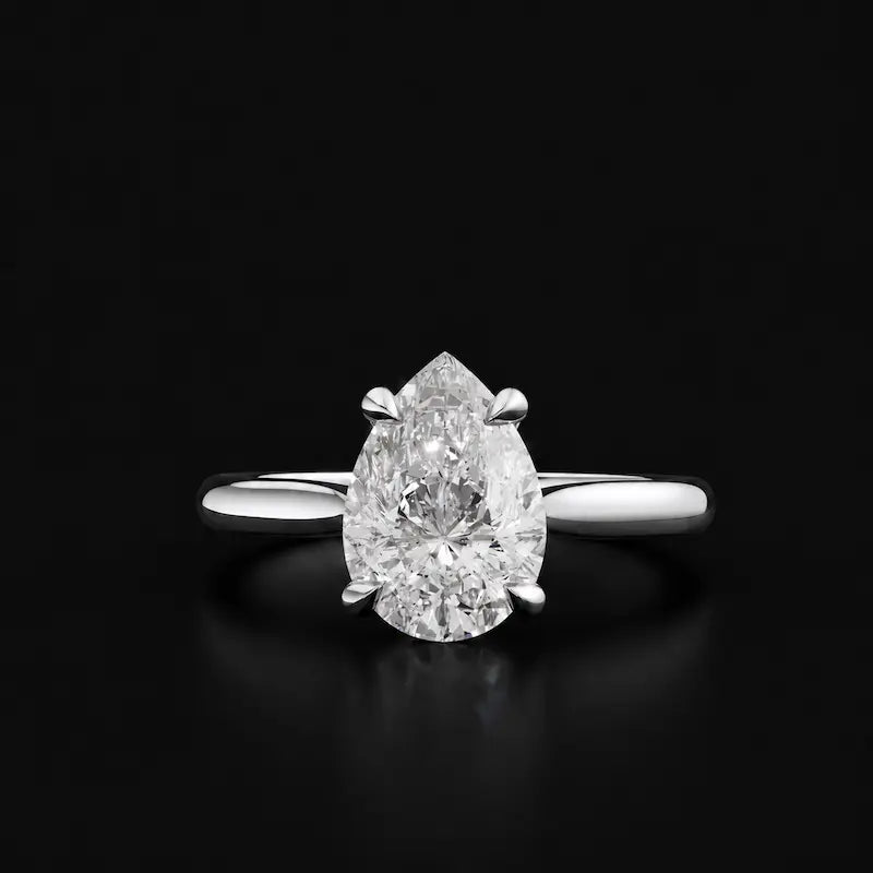 Front view of a 1.5 carat pear cut diamond solitaire engagement ring in an 18kt white gold 4 claw setting by TJ Diamond