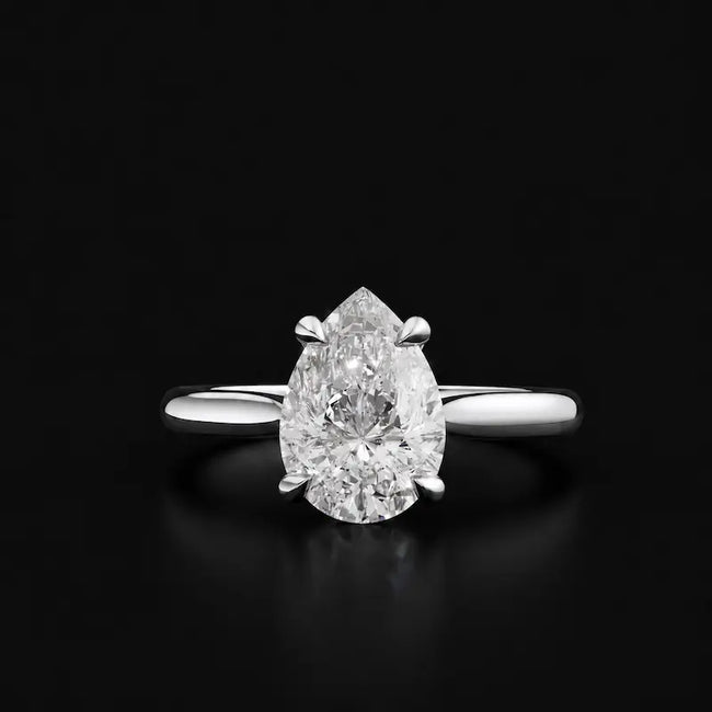 Front view of a 1.5 carat pear cut diamond solitaire engagement ring in an 18kt white gold 4 claw setting by TJ Diamond