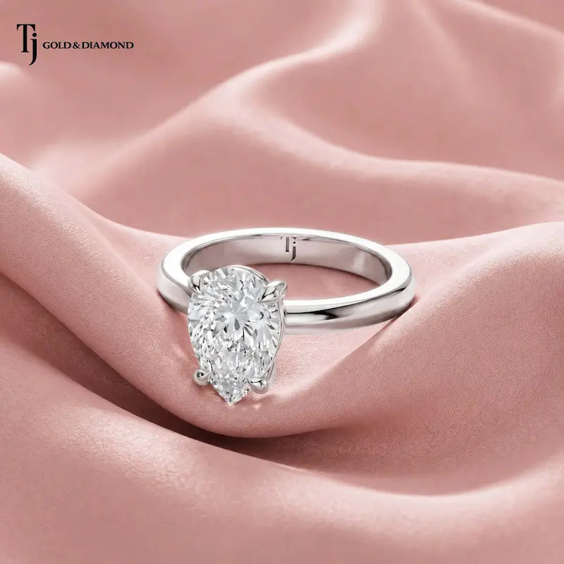 Front view of a 1.5 carat pear cut lab-grown diamond solitaire engagement ring in 18kt white gold with a 4-claw setting
