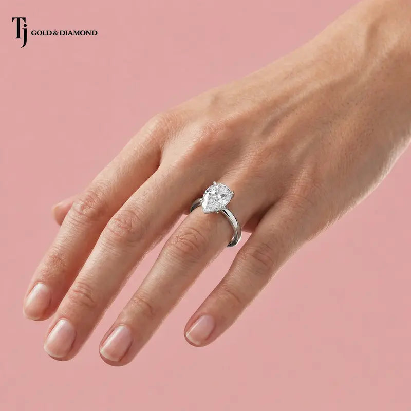 1.5 carat pear cut lab-grown diamond solitaire engagement ring in 18kt white gold worn on hand