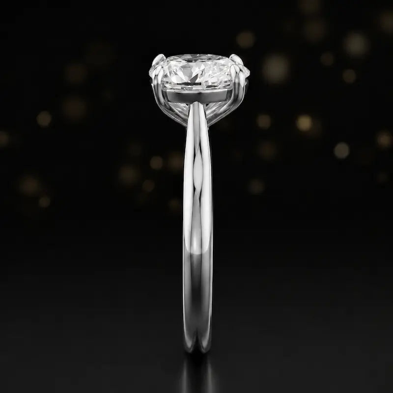 Side profile of a 1.5 carat pear cut diamond solitaire engagement ring showing the cathedral setting and 18kt white gold band by TJ Diamond