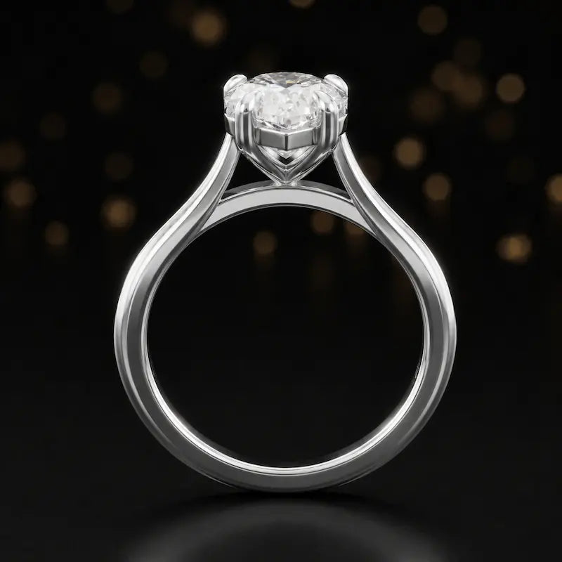 Front-on view of a 1.5 carat pear cut diamond solitaire engagement ring showing the full 18kt white gold band and 4 claw cathedral setting by TJ Diamond