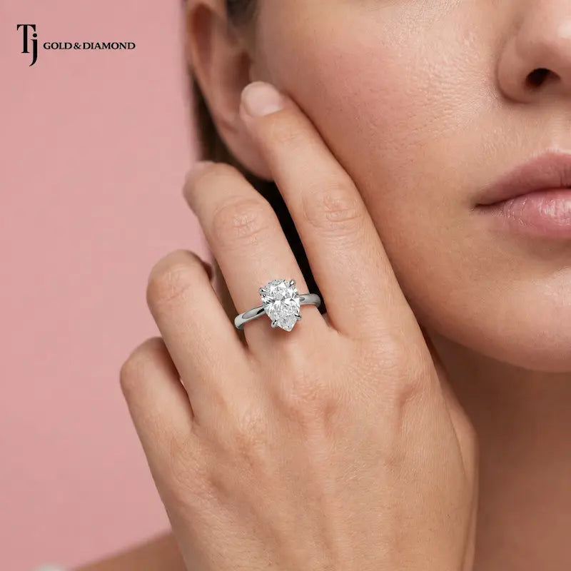 1.5 carat pear cut lab-grown diamond solitaire engagement ring in 18kt white gold on model