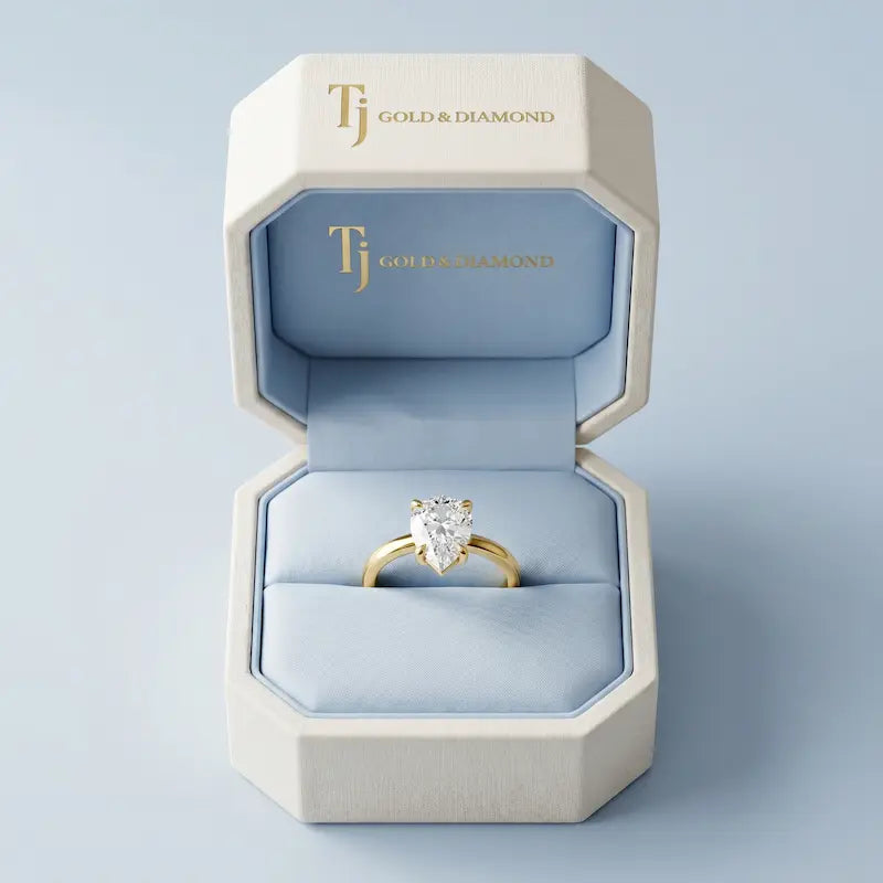 1.5 carat pear cut lab-grown diamond solitaire engagement ring in 18kt yellow gold in a TJ Diamond box