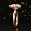 Side profile of a 1.5 carat pear cut diamond solitaire engagement ring showing the cathedral setting and 18kt rose gold band by TJ Diamond