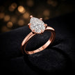 Front-on view of a 1.5 carat pear cut diamond solitaire engagement ring showing the full 18kt rose gold band and 6 claw cathedral setting by TJ Diamond