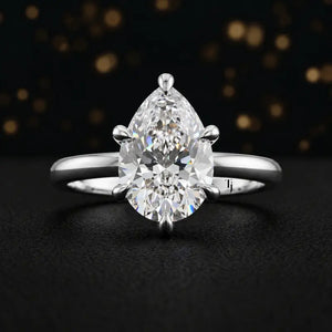 Front view of a 1.5 carat pear cut diamond solitaire engagement ring in an 18kt white gold 6 claw setting by TJ Diamond